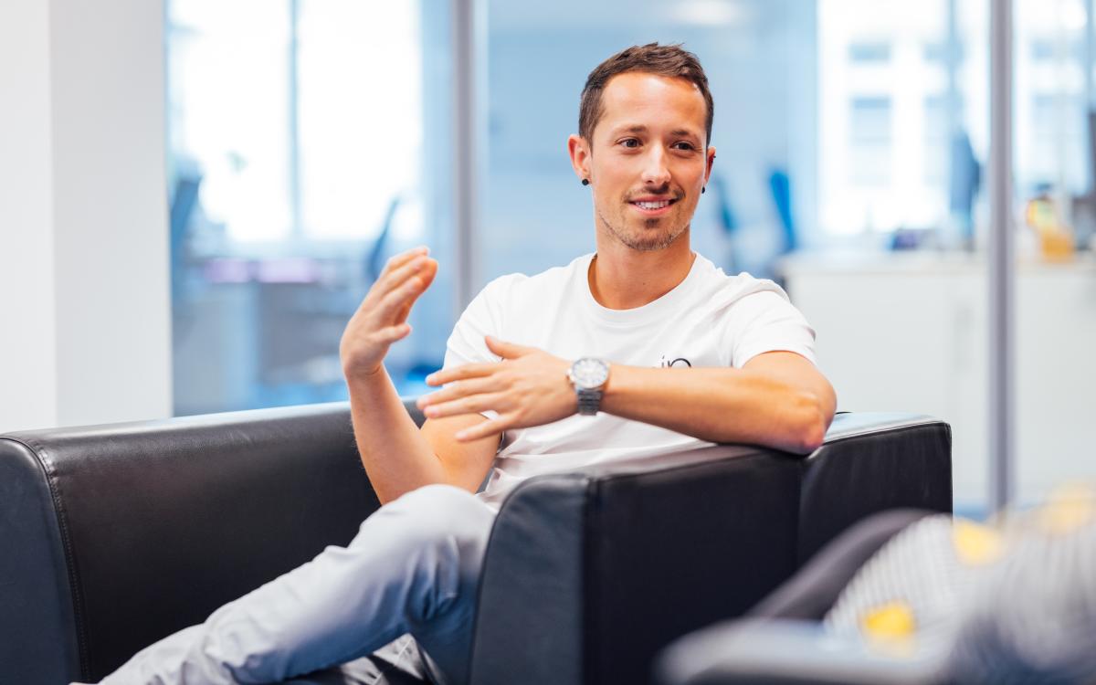 young man sitting in a chair, gesture with his hands