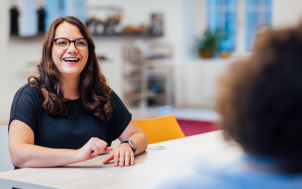 portrait of brunette woman with glasses laughing