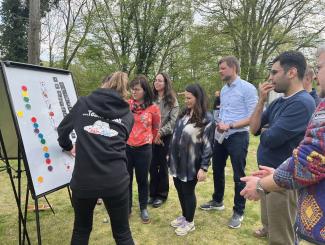 people standing around a board playing a game