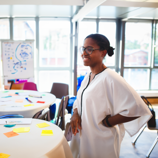 women standing at a table with sticky notes